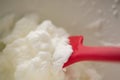 Close up of red spatula and whipped cream Royalty Free Stock Photo