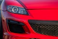 Close Up Red Sports Car Headlight and Bumper