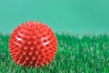 close up red therapy ball for massage on grass background