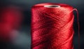 Close-up of a red thread spool shows the fine texture and intricate winding pattern. Royalty Free Stock Photo