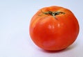 Close up of red tomato against white background Royalty Free Stock Photo