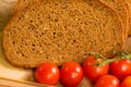 Close up of red tomatoes and slices of rye bread Royalty Free Stock Photo