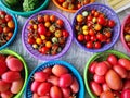 Close-up Red Tomatoes and Small Berries in Baskets for Sale