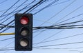 Close up of red traffic light and many wires