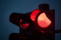 Close up of a red traffic signal light illuminated in the dark Royalty Free Stock Photo