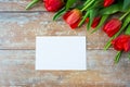 Close up of red tulips and blank paper or letter Royalty Free Stock Photo