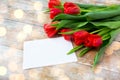 Close up of red tulips and blank paper or letter Royalty Free Stock Photo