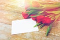 Close up of red tulips and blank paper or letter Royalty Free Stock Photo