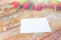 Close up of red tulips and blank paper or letter Royalty Free Stock Photo