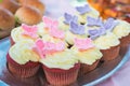 Close-up of red velet cupcakes with white cream cheese on top decorated with colorful butterflies. Catering for burthday Royalty Free Stock Photo
