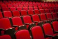 Close up of red velvet theater seats in rows with no people in them Royalty Free Stock Photo