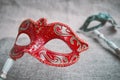 Close up, Selective focus on red venetian masquerade, carnival mask with blurry green mask background Royalty Free Stock Photo