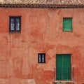 Close up of red vintage house wall with fourth windows. Color bl Royalty Free Stock Photo