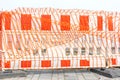 Close-up of red and white barrier for pavement repair works.