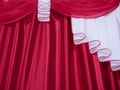 Close up of red and white color lambrequin and curtains, silk texture with folds, fabric Royalty Free Stock Photo