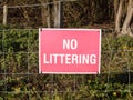 Close up of red and white country sign no littering