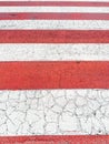 Close-up of a red and white crosswalk.
