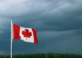 Canadian Flag Waves Ahead of Dark Storm Clouds Royalty Free Stock Photo