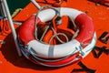 Close-up of a red and white weatherd life-belt (buoyancy aid) on