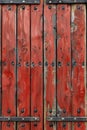 A close up of a red wooden door with metal rivets, AI Royalty Free Stock Photo