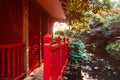 Close up red wooden house in japanese style garden, park with pond and autumn trees. Traditional japan architecture. Exterior Royalty Free Stock Photo