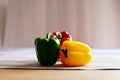 Close up of The red, yellow and green bell peppers placed on wooden background in Thailand. Concept for health and vitamins. Royalty Free Stock Photo