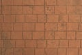 The reddish brown brick wall rough blocks, close-up horizontal textured and background.