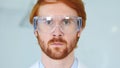 Close Up of Redhead Reseach Scientist, Doctor in Protective Glasses Royalty Free Stock Photo