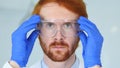 Close Up of Redhead Reseach Scientist, Doctor Wearing Protective Glasses