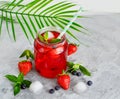 Close-up of a refreshing summer lemonade in a glass cup of lemon, lime, strawberry, mint with piles of ice, top view. Summer Royalty Free Stock Photo