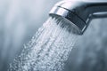 Close-up of refreshing water flowing from a modern bathroom showerhead Royalty Free Stock Photo