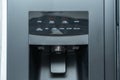 Close-up of a refrigerator's control panel with display and water dispenser. Royalty Free Stock Photo