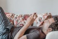 Close up of a relaxed Caucasian man using smart phone lying on couch in the living room at home Royalty Free Stock Photo