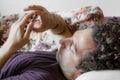 Close up of a relaxed Caucasian man using smart phone lying on couch in the living room at home Royalty Free Stock Photo