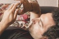 Close up of a relaxed Caucasian man using smart phone lying on couch in the living room at home Royalty Free Stock Photo