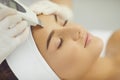 Close-up of relaxed womans face getting ultrasound apparatus facial cleaning Royalty Free Stock Photo