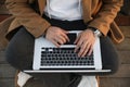 Close-up of relaxed young man using laptop outdoor. Freelance. Royalty Free Stock Photo