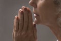 Close up religious faithful mature woman praying with hope Royalty Free Stock Photo