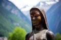 close-up of a religious statue placed against a mountain village backdrop Royalty Free Stock Photo