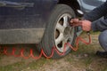 Close up of repair of a flat tire with tire inflation with a compressed air compressor where the tire visibly swells