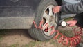 Close up of repair of a flat tire with tire inflation with a compressed air compressor where the tire visibly swells