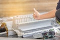 Close up of Repairman giving thumb up after cleaning air conditioner compartment