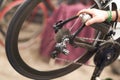 Close up of repairman is holding spray lubricant in his hand to lubricate the bike chain