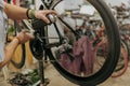 Close up of repairman is holding spray lubricant in his hand to lubricate the bike chain