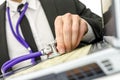 Close up of repairman holding stethoscope of laptop keyboard Royalty Free Stock Photo