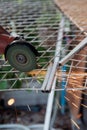 Close-up of a repairman using a metal grinding machine to cut a plastic block used to show off in a shop.