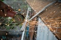 Close-up of a repairman using a metal grinding machine to cut a plastic block used to show off in a shop.