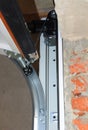 Close up on replace, repair a broken garage door spring and garage door opener system