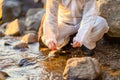 Close-up of researcher collecting water sample at seashore Royalty Free Stock Photo