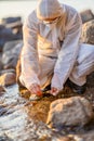 Close-up of researcher collecting water sample at seashore Royalty Free Stock Photo